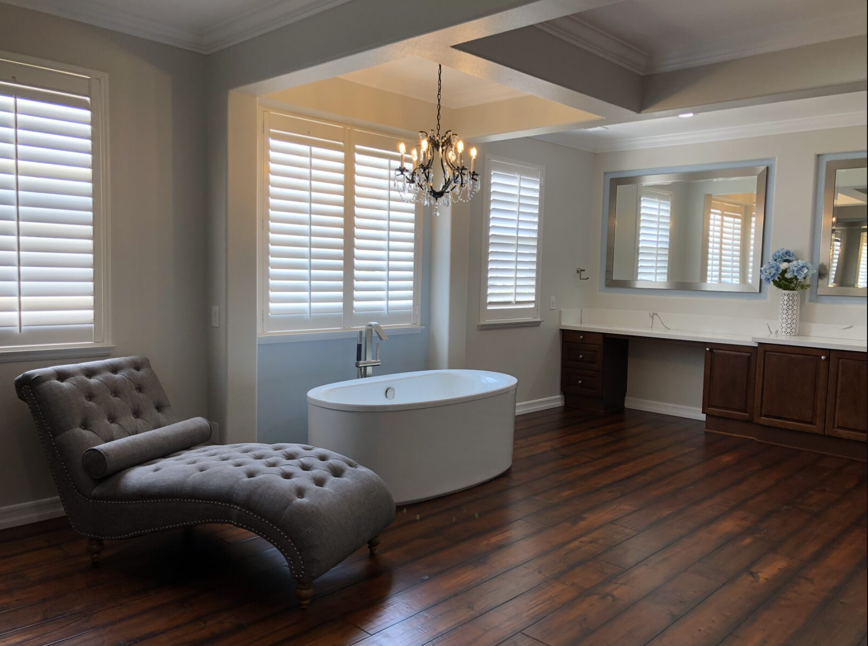 Luxury master bathroom with freestanding tub and chandelier